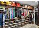 Well-organized walk-in closet with wooden shelving, hanging clothes, and personal belongings at 719 21St N Ave, St Petersburg, FL 33704