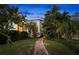 Charming home exterior showcasing lush landscaping and a welcoming walkway to the front door at 719 21St N Ave, St Petersburg, FL 33704