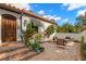 Inviting outdoor sitting area featuring a brick patio, lush greenery, and a stucco wall at 719 21St N Ave, St Petersburg, FL 33704