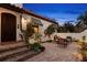 Inviting outdoor sitting area featuring a brick patio, lush greenery, and a stucco wall at 719 21St N Ave, St Petersburg, FL 33704