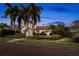 Beautiful home with a red tile roof, surrounded by mature palm trees and meticulously maintained landscaping at 719 21St N Ave, St Petersburg, FL 33704