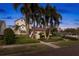 Beautiful home with a red tile roof, surrounded by mature palm trees and meticulously maintained landscaping at 719 21St N Ave, St Petersburg, FL 33704