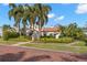 Charming home with a tile roof, lush landscaping, and a brick walkway at 719 21St N Ave, St Petersburg, FL 33704