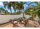 Outdoor seating area featuring a brick patio, stucco wall, and lush greenery at 719 21St N Ave, St Petersburg, FL 33704