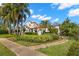 Charming home featuring lush landscaping, a red tile roof, and a welcoming garden path at 719 21St N Ave, St Petersburg, FL 33704