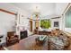 Cozy living room with a fireplace, unique chandelier, and large picture window at 719 21St N Ave, St Petersburg, FL 33704