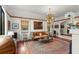 Bright living room showcasing large rug, unique lighting, and access to other areas of the home at 719 21St N Ave, St Petersburg, FL 33704