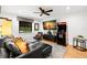 Comfortable living room with black leather couch, ceiling fan, and an arcade game for entertainment at 719 21St N Ave, St Petersburg, FL 33704