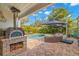 Outdoor kitchen with wood-fired pizza oven and a view of the backyard pool at 719 21St N Ave, St Petersburg, FL 33704