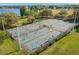 Aerial view of well-maintained pickleball and tennis courts, surrounded by lush greenery and active players at 719 21St N Ave, St Petersburg, FL 33704