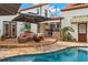 Outdoor poolside living offers a built-in kitchen, fire pit, and a covered patio sitting area at 719 21St N Ave, St Petersburg, FL 33704