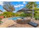 Backyard pool with outdoor lounge area, dining set, and lush tropical landscaping at 719 21St N Ave, St Petersburg, FL 33704