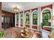 Bright sunroom with arched windows, patterned rug, and unique light fixture at 719 21St N Ave, St Petersburg, FL 33704