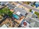 Aerial view of a home with a pool, patio, and xeriscaped front yard in a residential neighborhood at 7635 Sue Ellen Dr, Port Richey, FL 34668