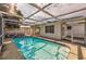 View of a screened-in pool with an open-air roof that has some lounge chairs nearby at 7635 Sue Ellen Dr, Port Richey, FL 34668