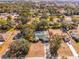 An aerial view of a house with a large backyard, pool with enclosure, and mature trees in a neighborhood at 7948 Floral Dr, Weeki Wachee, FL 34607