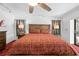 Inviting bedroom with a large bed, ceiling fan, bedside lamps, and stylish decor for a cozy retreat at 7948 Floral Dr, Weeki Wachee, FL 34607