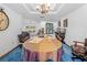 Spacious dining room with blue carpet and views of the outdoor pool at 7948 Floral Dr, Weeki Wachee, FL 34607