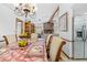 Inviting dining room with decorative table setting and fruit basket, flowing into a cozy living space with a fireplace at 7948 Floral Dr, Weeki Wachee, FL 34607