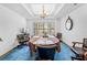 Formal dining room with blue carpet, chandelier, and large bay window at 7948 Floral Dr, Weeki Wachee, FL 34607