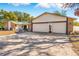 Paver driveway leads to a spacious two-car garage of this home with brick and siding accents at 7948 Floral Dr, Weeki Wachee, FL 34607