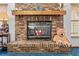 Close up of the brick fireplace with wooden mantle and hearth, plus a decorative teddy bear at 7948 Floral Dr, Weeki Wachee, FL 34607