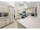 Well-lit kitchen featuring tile floors and ample countertop space at 7948 Floral Dr, Weeki Wachee, FL 34607