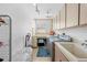 Well-lit laundry room with modern washer and dryer, and tiled floors at 7948 Floral Dr, Weeki Wachee, FL 34607