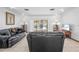 Bright living room featuring tile floors, neutral walls, and views of the pool area through sliding glass doors at 7948 Floral Dr, Weeki Wachee, FL 34607