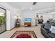 Cozy living room with tile flooring, a decorative rug, and an entertainment center at 7948 Floral Dr, Weeki Wachee, FL 34607