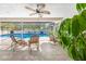 Covered patio with ceiling fan, tile flooring, and views of the pool area at 7948 Floral Dr, Weeki Wachee, FL 34607