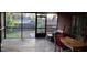 View of screened porch with wooden deck, outdoor dining table set with a glimpse of the backyard at 8006 N Temple Pl, Tampa, FL 33617