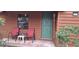 Close-up of the porch featuring chairs, a green front door, and the house number at 8006 N Temple Pl, Tampa, FL 33617