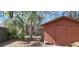 A small shed sits in the yard, accented by surrounding trees, and a lawn at 8006 N Temple Pl, Tampa, FL 33617