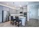 Beautiful kitchen with a central island, stainless steel appliances, and gray cabinetry providing a modern and functional space at 811 Winterside Dr, Apollo Beach, FL 33572