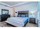 Comfortable main bedroom featuring dark wood furniture, neutral decor, and tray ceilings, perfect for relaxation at 811 Winterside Dr, Apollo Beach, FL 33572