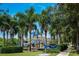 Wolf Creek Park playground is surrounded by mature shade trees and lush landscaping at 811 Winterside Dr, Apollo Beach, FL 33572