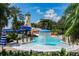 Community pool area features a splash fountain, a lighthouse, waterslide, and palm trees at 811 Winterside Dr, Apollo Beach, FL 33572