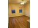 Bright, empty bedroom with hardwood floors and plenty of natural light at 8137 Cottonwood Ct, Seminole, FL 33776