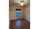 Bedroom featuring a wood floor, a ceiling fan, and a window at 8137 Cottonwood Ct, Seminole, FL 33776