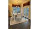 Elegant dining room with modern furniture, a decorative rug, and natural light streaming in from the windows at 8137 Cottonwood Ct, Seminole, FL 33776