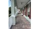 Inviting front porch featuring brick pavers and decorative columns at 8137 Cottonwood Ct, Seminole, FL 33776