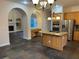 Open concept kitchen with large island and stone floors, stainless steel appliances, and arched doorways at 8137 Cottonwood Ct, Seminole, FL 33776