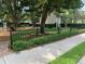 Community playground, framed by a black fence and lush greenery, enhances the Gathering-friendly environment at 8137 Cottonwood Ct, Seminole, FL 33776