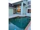 Backyard pool surrounded by neutral brick coping at 8137 Cottonwood Ct, Seminole, FL 33776