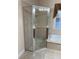 A tiled glass enclosed shower features tile accents and a modern shower head at 8137 Cottonwood Ct, Seminole, FL 33776