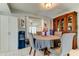 Lovely dining room featuring a round table with seating for four, bright window and wooden display cabinet at 8417 Moulton Dr, Port Richey, FL 34668