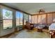 View of the bright sunroom with lots of natural light, tile flooring, and access to the backyard at 8417 Moulton Dr, Port Richey, FL 34668