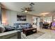 Inviting living room features a gray sofa with patterned pillows, a ceiling fan and a large framed art piece at 8417 Moulton Dr, Port Richey, FL 34668