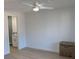 Bright bedroom with ceiling fan and view to en-suite bathroom with updated vanity at 8480 60Th N St # 801, Pinellas Park, FL 33781